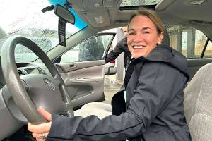 Chilliwack care aide Brooke Wilson behind the wheel of the new-to-her 2004 Toyota Camry, at Fix Auto Chilliwack where she learned she was the 2025 winner of the Annual Christmas Car Giveaway Contest. (Jennifer Feinberg/ Chilliwack Progress)